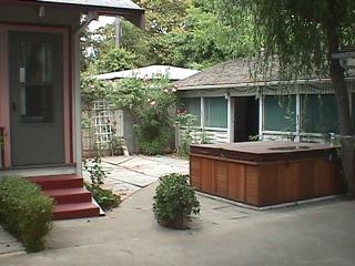 The backyard: This is view of our backyard taken shortly after we bought the house. It looks pretty much the same today with the hot tub, cement, and patio room. I managed to kill a few plants, but only those that I wanted to get rid of. The roses are still going strong.